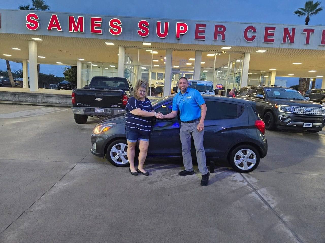 Marcos celebrating a customer's vehicle delivery